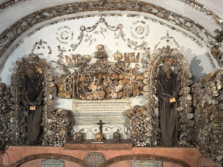 Bones and skulls arranged into an arch and a coat of arms in the Capuchin Crypt
